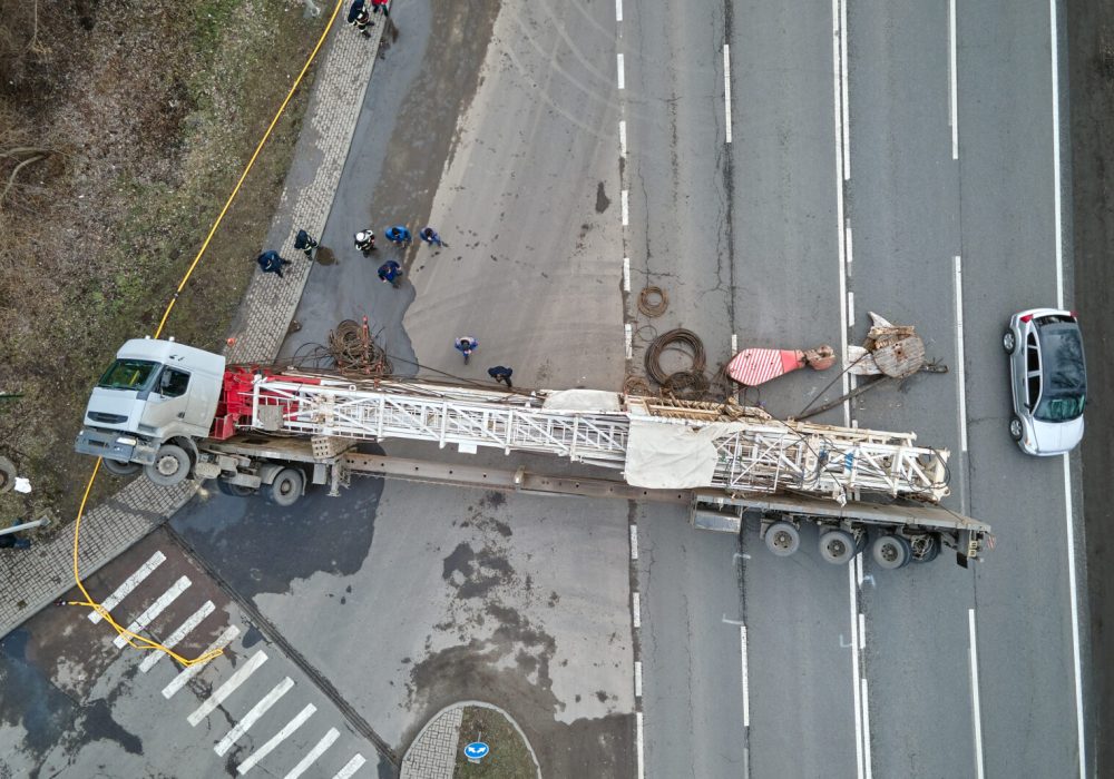 Aerial view of road accident with overturned truck blocking traffic.